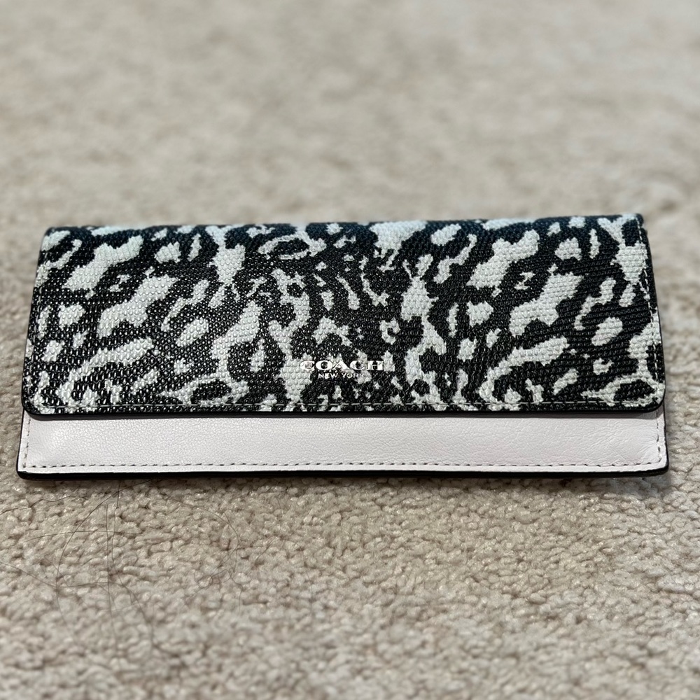 Like NEW white and black Coach Wallet leather with embossed detailed flap.